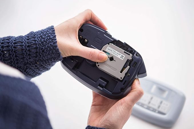 Brother PT-M95 Label Maker, P-Touch Label Printer, Handheld, QWERTY Keyboard, Up to 12mm Labels, Includes Black on White Tape Cassette